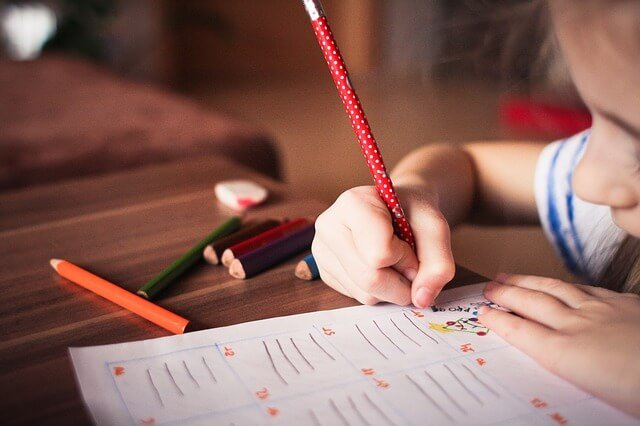 A little girl writing.