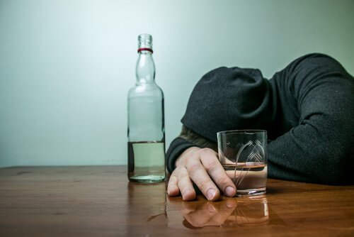 Man with a bottle of alcohol.