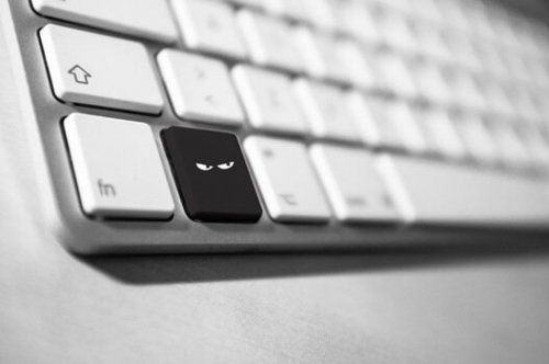 A computer key with a mean face.