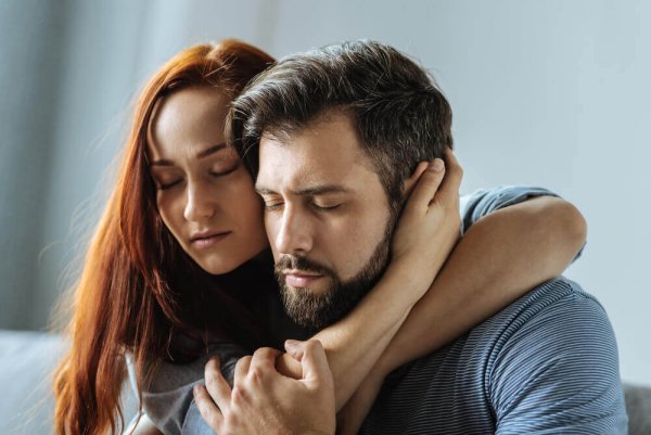 A couple in a codependent relationship embracing.