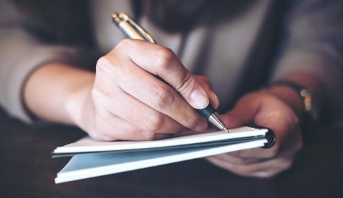 A man writing.