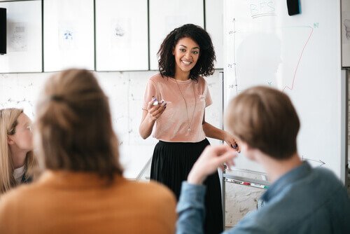 Girl giving a presentation to her coworkers.