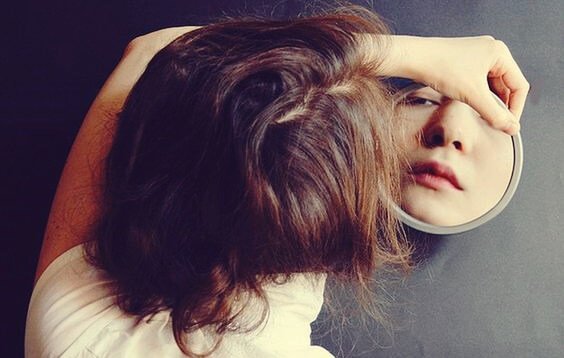 Girl looking in the mirror.