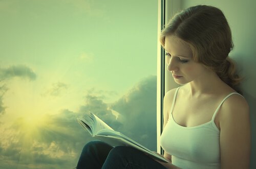 Girl reading book by the window.