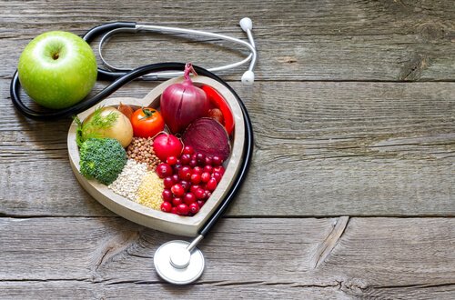 Vegetables and fruits in a heart-shaped plate.