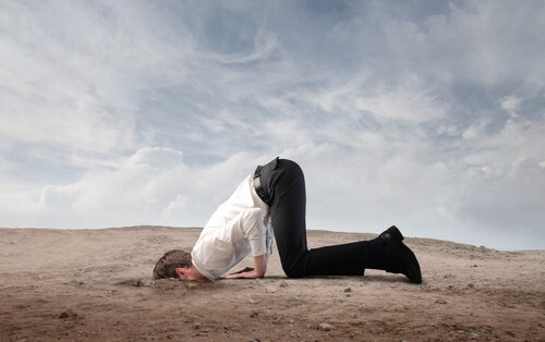 Man buring his head in the sand.