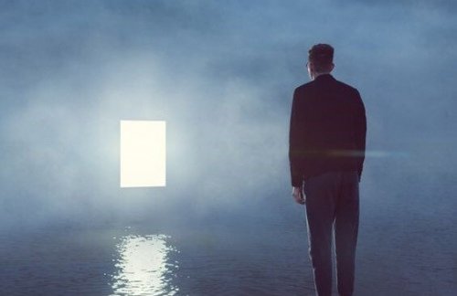 A man looking at an open door.