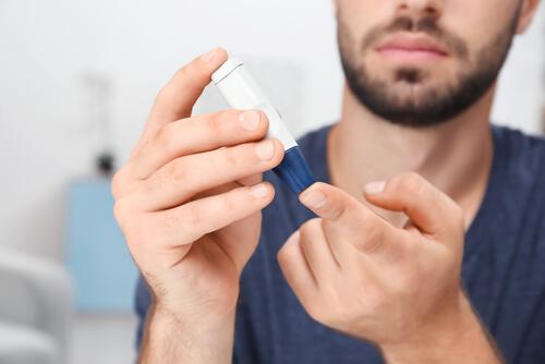A man with diabetes checking his blood sugar.
