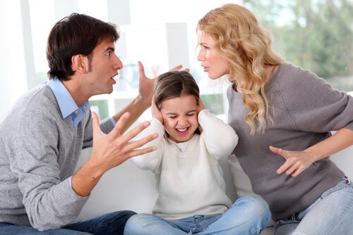 Child covering her ears while her parents fight. 