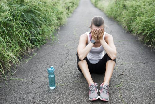 An exhausted runner sitting on the ground.