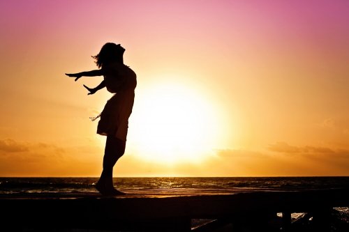 Woman enjoying the sunset at the beach.