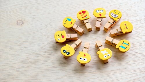 Wooden clips representing different emotions. 