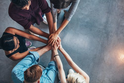 Colleagues gathering hands.
