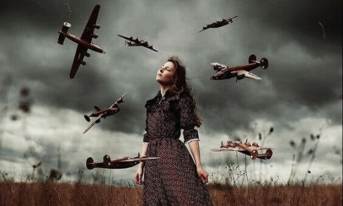 A woman standing in a field with a stormy sky behind her, surrounded by miniature airplanes in flight.