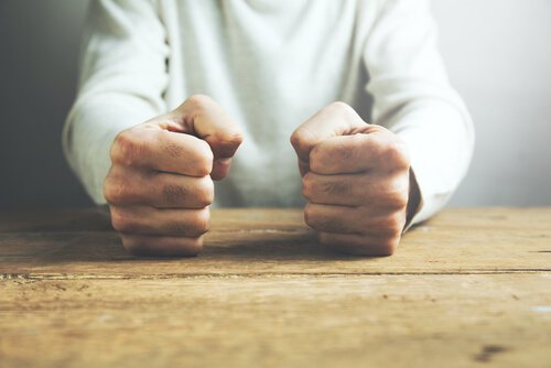 A man clenching his fists. 