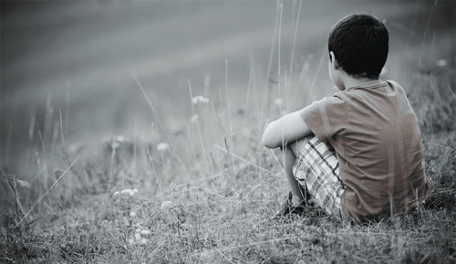 A child sitting on the ground by himself.