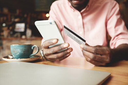 A man buying something with his phone.
