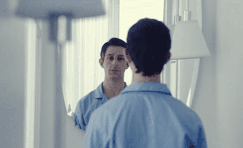 A man going through mirror exposure therapy.