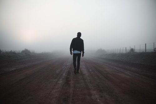 A man walking through the fog.