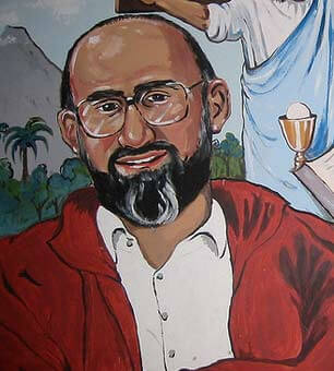 A portrait of Martín-Baró shows him smiling kindly.
