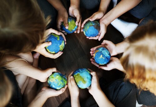 People holding globes in hands.