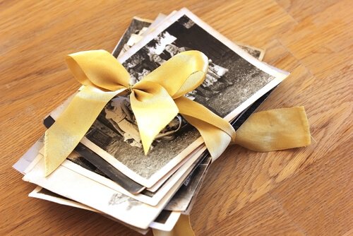 Photos of positive memories tied together with a ribbon.