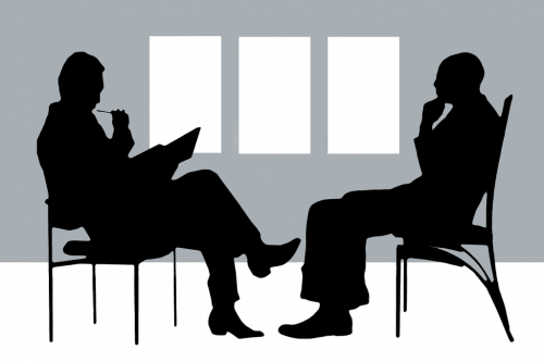 Psychologist sitting in front of his patient.