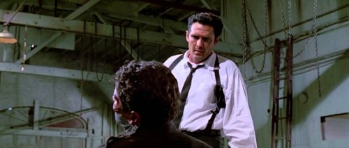 A still of the ear-cutting scene from the film Reservoir Dogs.