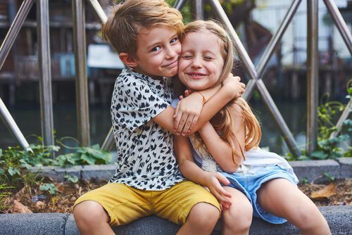 Brother and sister hugging.