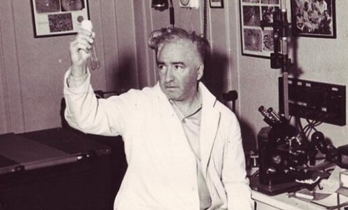Wilhelm Reich holding two test tubes.