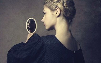 A narcissistic woman looking at herself in a mirror.