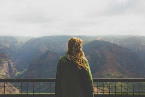 A woman looking at mountains.