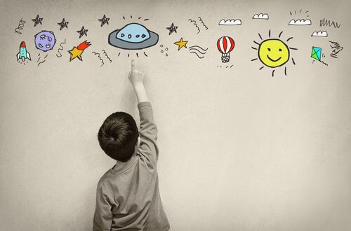 A kid drawing colorful images.