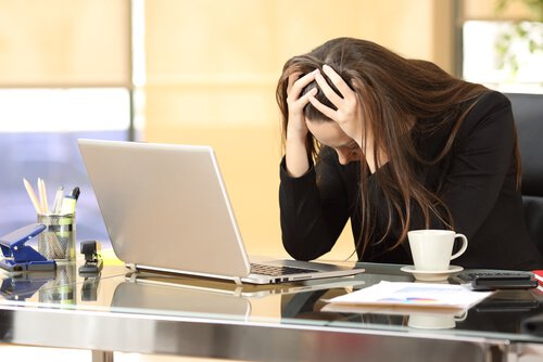 A stressed woman at her desk.