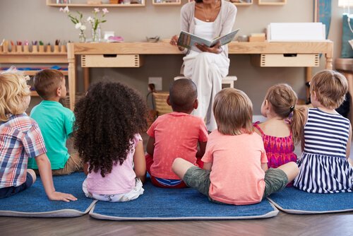 An educator reading a story to her students.
