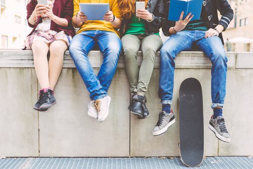 A group of friends on their electronic devices.