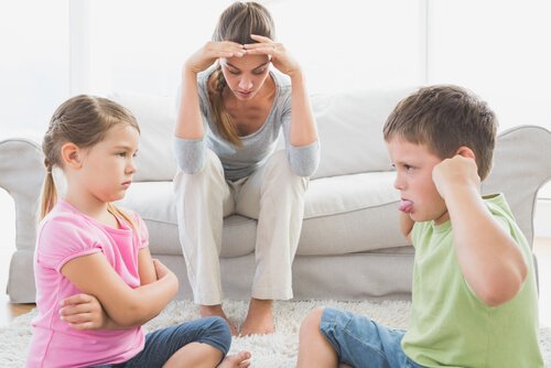 Children arguing in front of a frustrated caregiver.