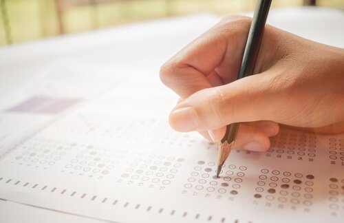 A person filling out an answer sheet.