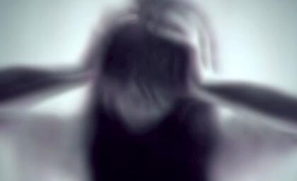 A woman holding her head.