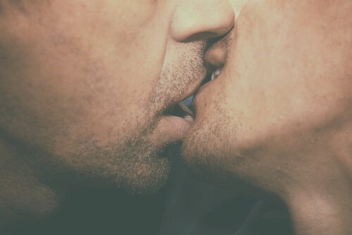Two men kissing.
