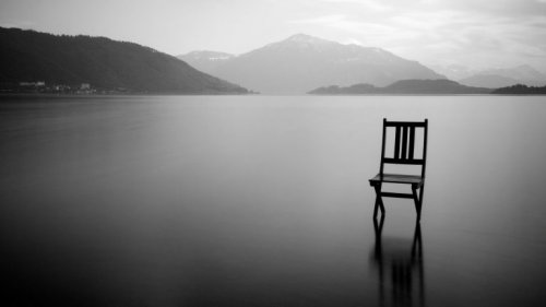 A chair on an empty lake.