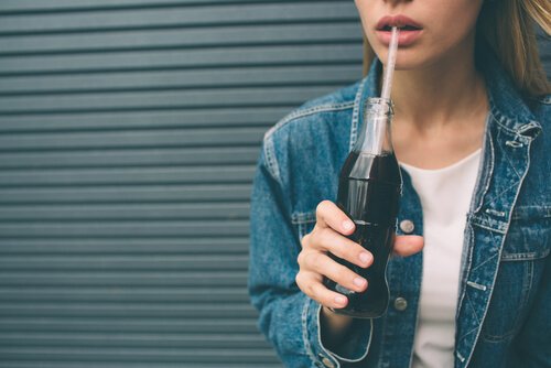 Teen drinking soda.