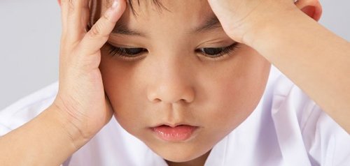 A little boy looking worried.