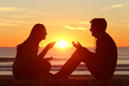 A couple talking at sunset.