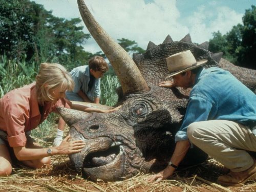 Scientists with a wounded dinosaur in the movie Jurassic Park.