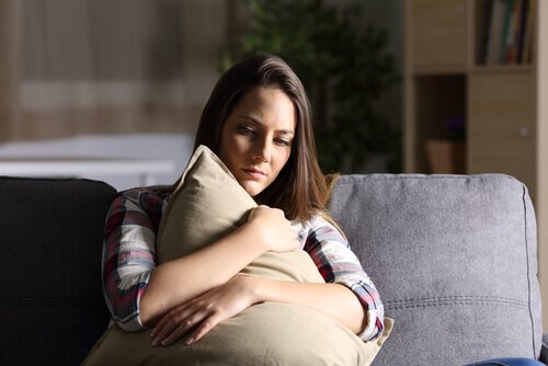 A woman hugging a pillow.