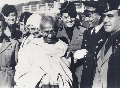 Gandhi surrounded by people.