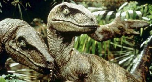 Two Velociraptors posing for a picture.