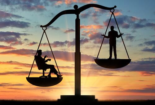 A scale balances two people.