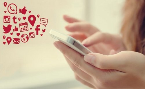 A woman checking her social media accounts on her smartphone.